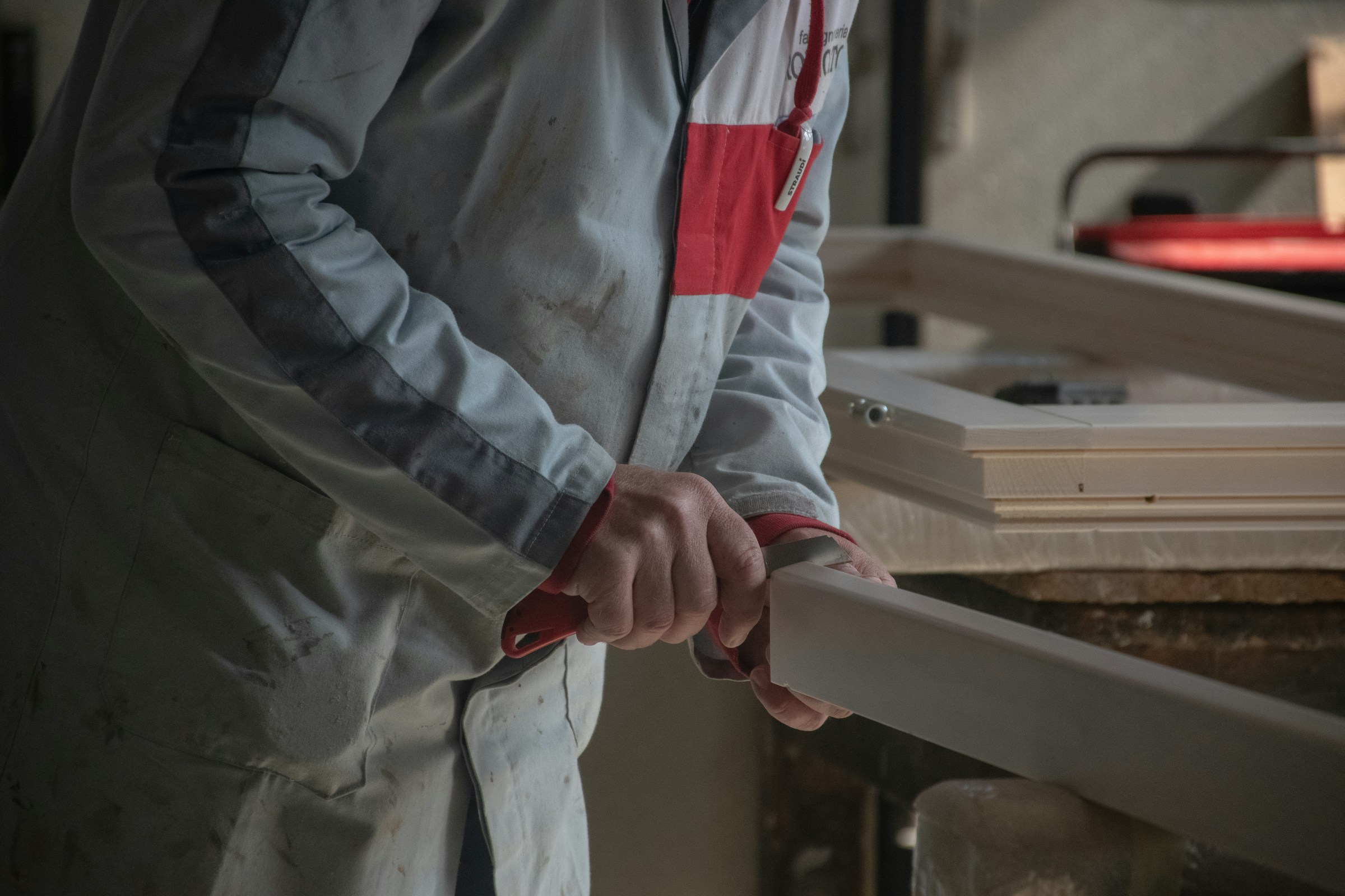 Craftsperson carefully shaping a piece of cabinetry